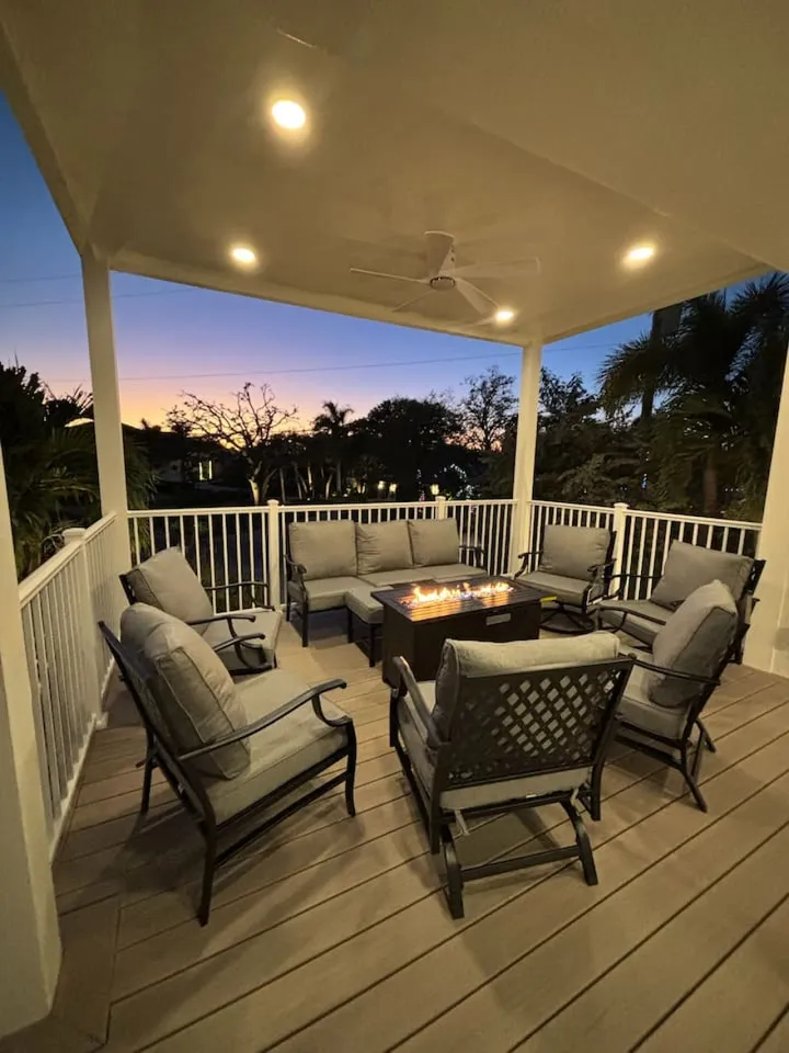 Sweetwater's covered deck with the fire table lit at sunset