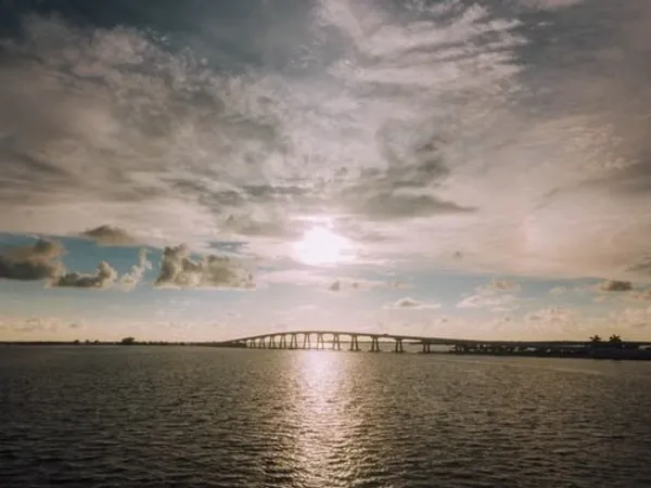 The sun over the Caloosahatchee River and the Cape Coral bridge