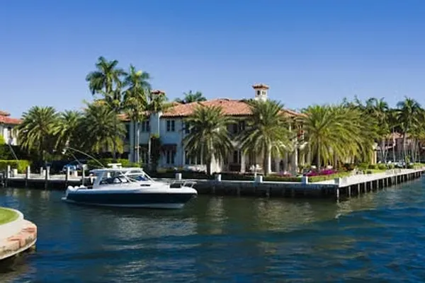 Canal-front homes with a boat on a Florida canal