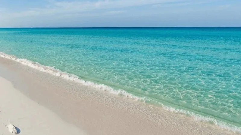 Turquoise water meeting white sand on the Gulf Coast